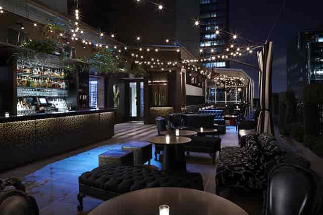 Sophisticated rooftop venue with skyline view, perfect for cocktail receptions.