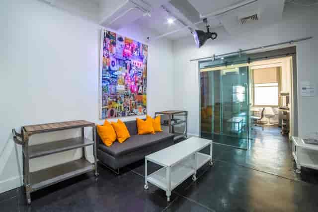 Contemporary meeting space with gray sofa, ideal for creative brainstorming sessions.