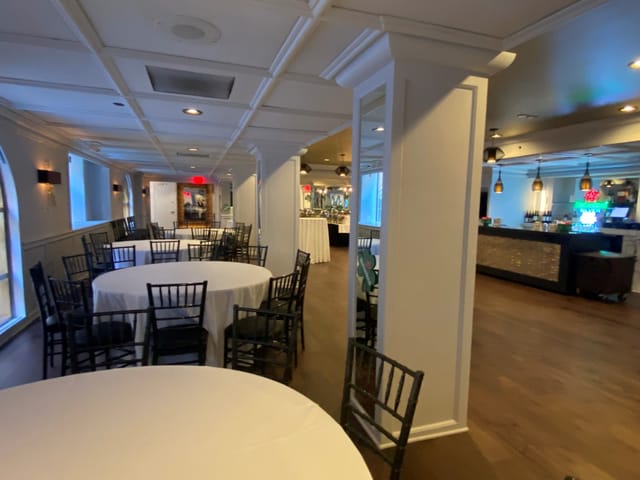 Broadway Room in Manhattan Manor with elegant round tables for corporate events and gatherings.