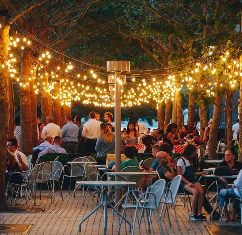 Outdoor event at P.J. Clarke's on the Hudson, featuring string lights and casual seating.