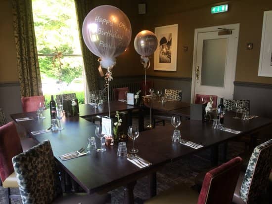 Intimate birthday celebration with elegant table settings in The Merlin's private dining area.
