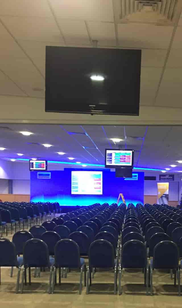 Bramham Hall event space with tiered seating and modern screens at Wetherby Racecourse.