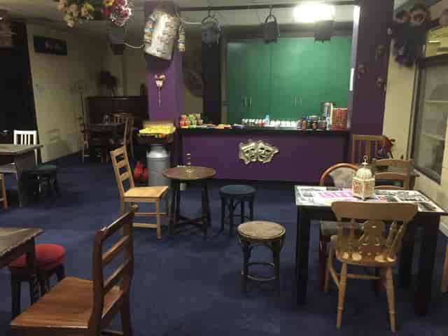Cozy meeting space at NWTAC Theatre with vibrant purple bar for casual gatherings