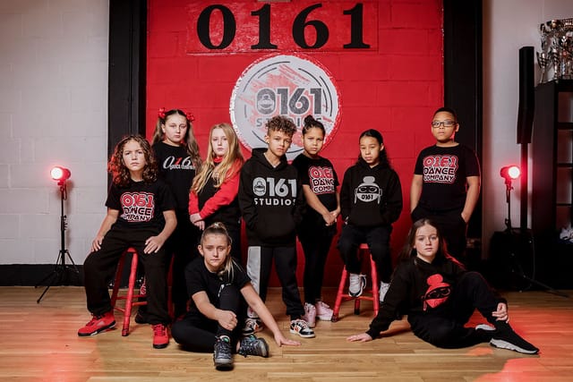 Young dancers in vibrant studio showcasing teamwork and creativity for events.