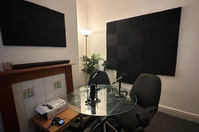 Soundproof podcast studio with microphones for meetings and collaborations.