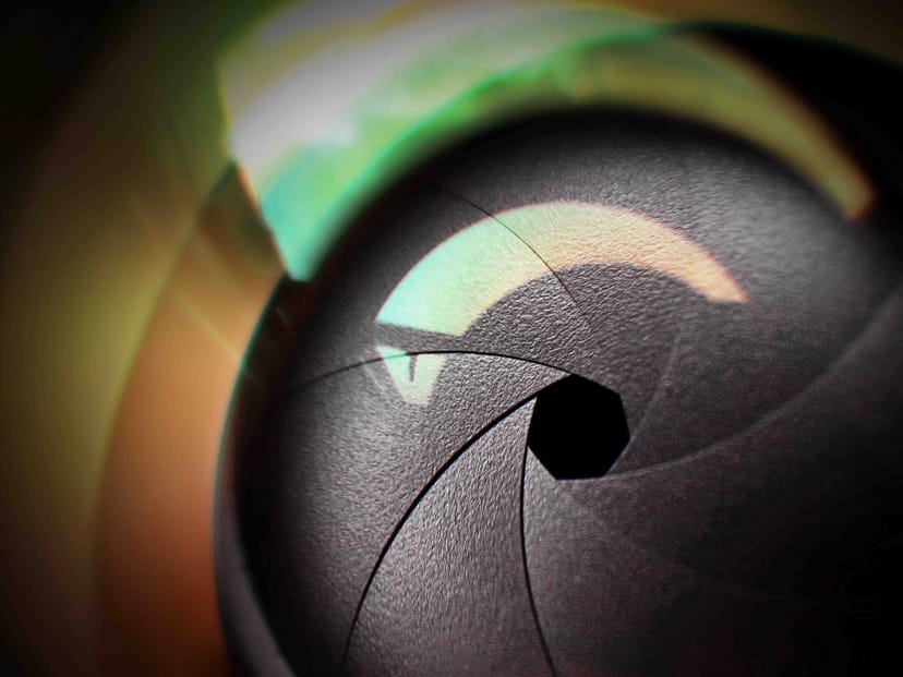 Abstract camera lens aperture at Zadina Gallery symbolizing event planning creativity.