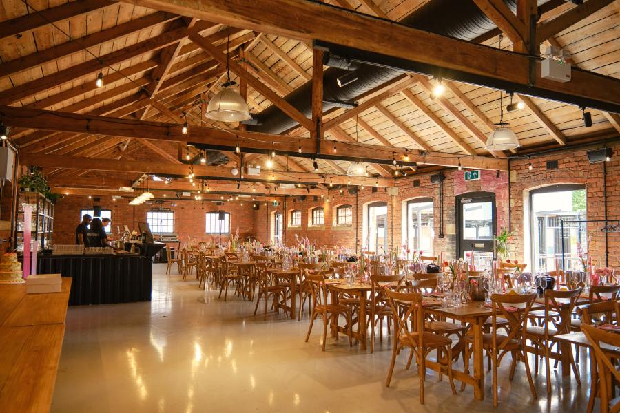 Event space in KickSonic with rustic beams, perfect for banquets and gatherings. - Banner
