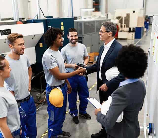 Professional handshake in a networking event showcasing collaboration and industry teamwork.