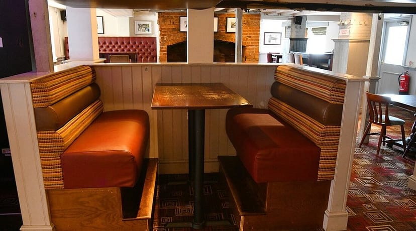 Cozy restaurant seating area with booths, ideal for casual meetings and team discussions.