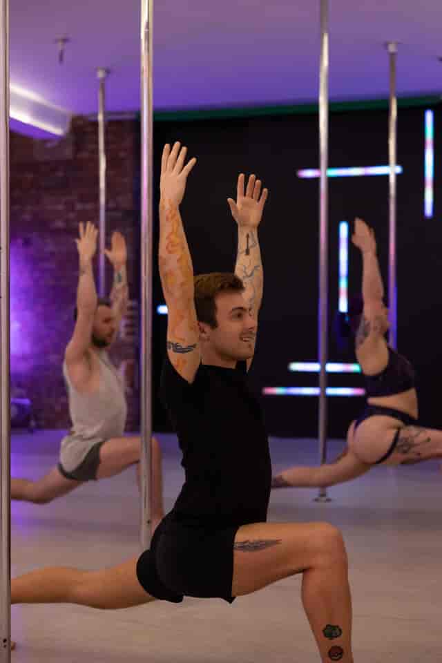 Dynamic group fitness class at GFFDamian Dance Studio with pole fitness for corporate retreats.
