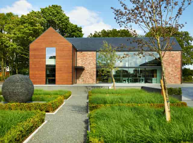 Modern event venue in Sector 6, featuring sleek wood and glass design, perfect for meetings.
