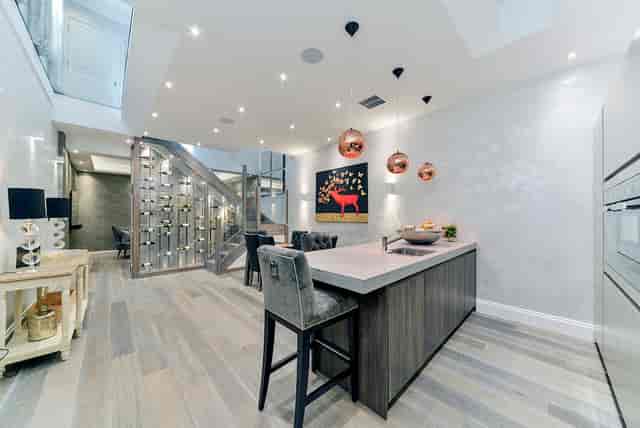 Modern kitchen with copper lighting, perfect for intimate gatherings and events.