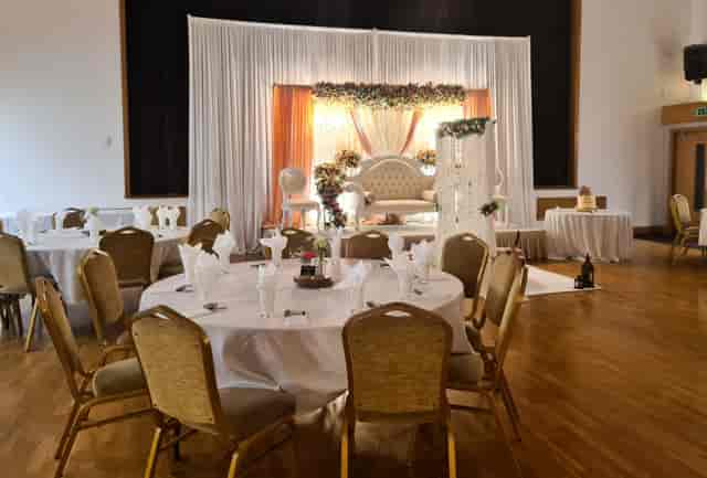 Elegant conference center with round tables, perfect for weddings and formal events.