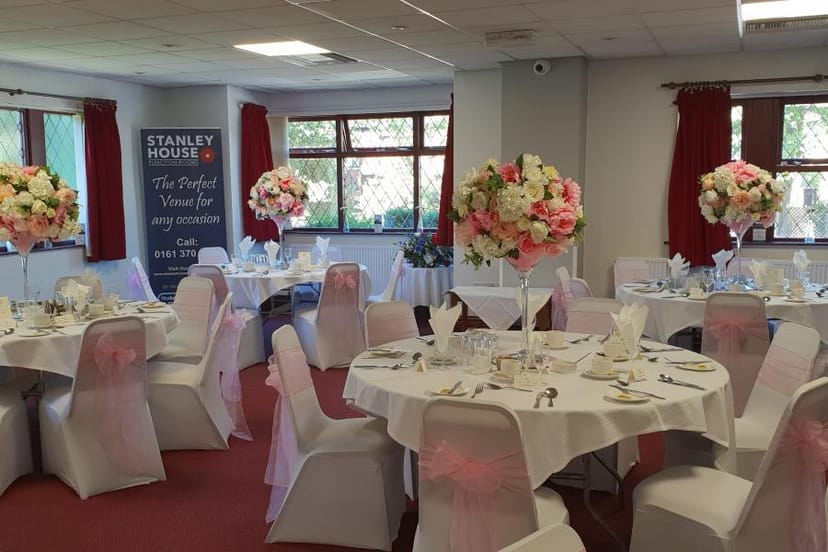 Elegant banquet hall with white linens for weddings and formal events.