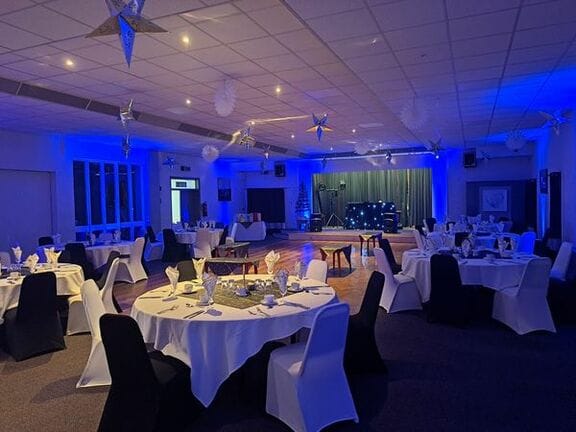 Elegant Windsor Suite with round tables, ideal for corporate events and celebrations.