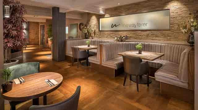 Contemporary bar area with warm wood tones, ideal for intimate gatherings and events.