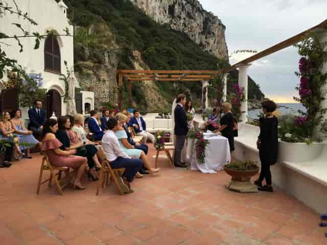 Intimate outdoor wedding at Bagni Tiberio, Capri beach club with floral decor.