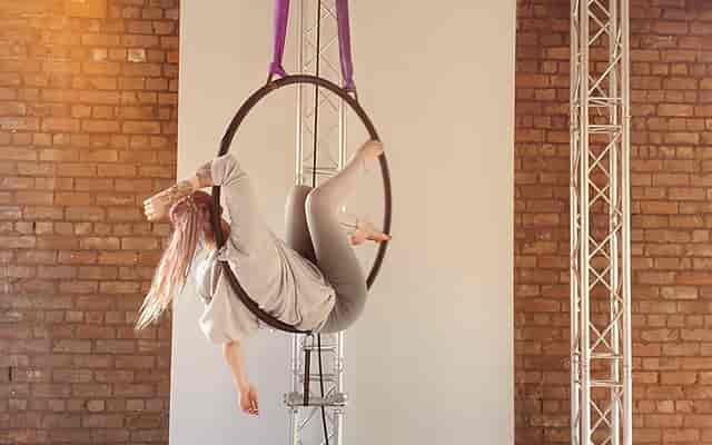 Aerial hoop performer in urban studio, showcasing creativity for events and galas.