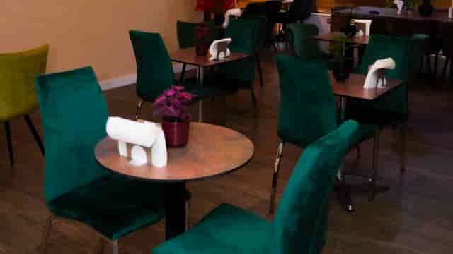Chic Buka Royale bar with green chairs for intimate networking and brainstorming events.