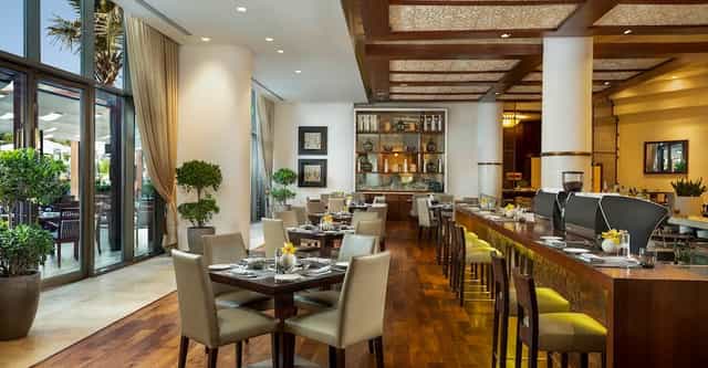 Elegant restaurant in Beach Rotana, ideal for events and meetings with natural light.
