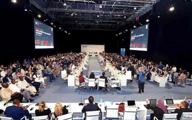 Conference Halls ADNEC Abu Dhabi with attendees at tables for a professional event.