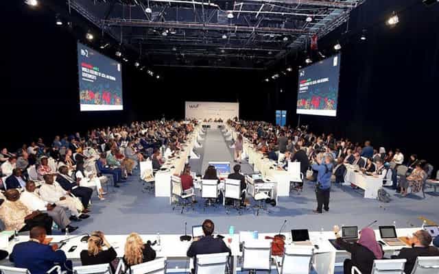 Conference Halls ADNEC Abu Dhabi with attendees at tables for a professional event.