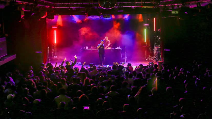 Electrifying live performance at Black Box venue with vibrant lights and engaged audience.