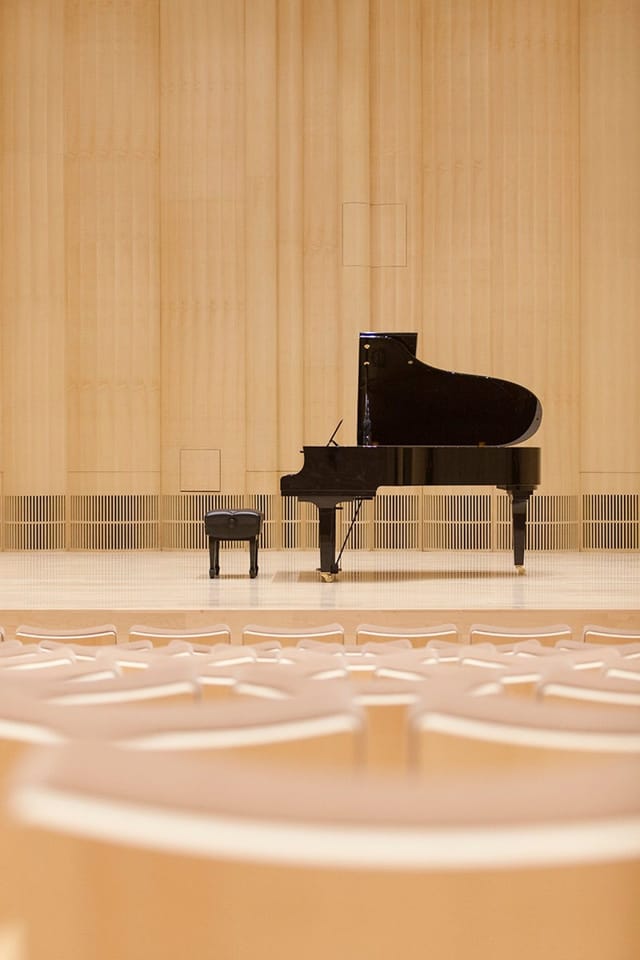 Blue Hall grand piano stage setup for elegant music events and performances.