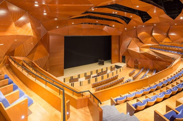 Modern amphitheater with geometric design, perfect for corporate events and performances.