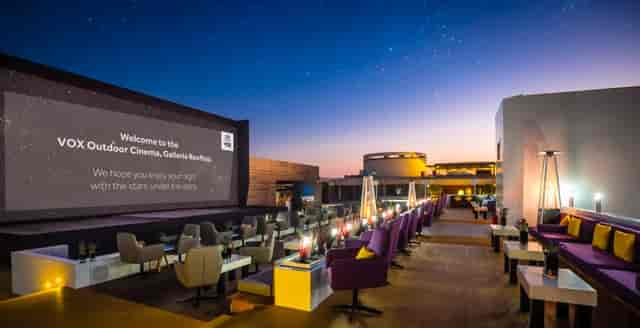 Drive-in movie theater setup with a large screen for outdoor evening events.