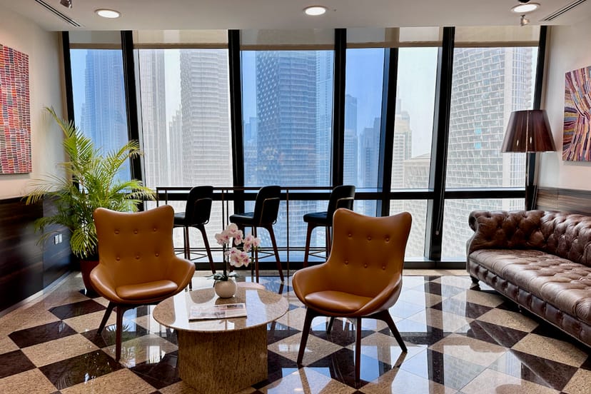 Sleek lounge for informal meetings, featuring modern furniture and city views.