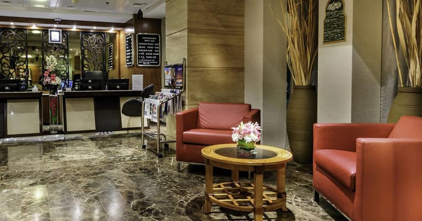 Welcoming reception area with red seating in Executive Suites, perfect for networking events.