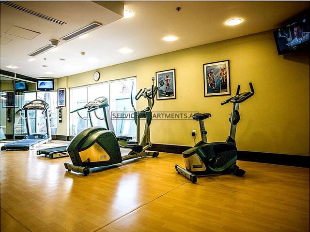 Well-equipped fitness area with elliptical machines for wellness during Executive Suites stays.