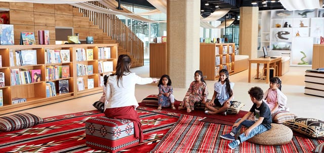 Colorful performing arts theater with cushions, ideal for workshops and family events.