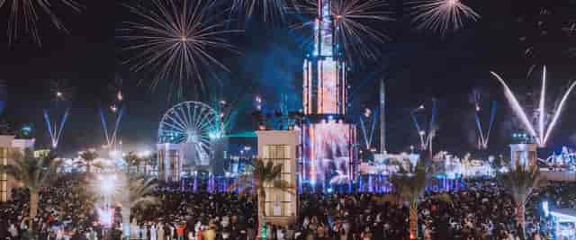 Sheikh Zayed Festival fireworks illuminate a lively outdoor crowd, ideal for events.