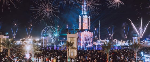Sheikh Zayed Festival fireworks illuminate a lively outdoor crowd, ideal for events.