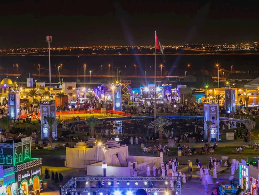 Vibrant Sheikh Zayed Festival grounds illuminated at night, perfect for social events.