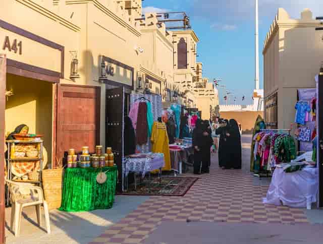 Heritage Village marketplace at Sheikh Zayed Festival, showcasing colorful artisanal goods.