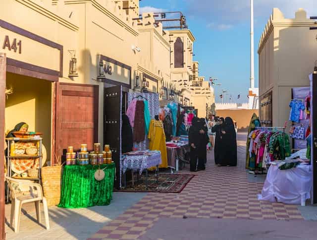 Heritage Village marketplace at Sheikh Zayed Festival, showcasing colorful artisanal goods.