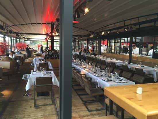 Outdoor terrace at The Harbour Club Amsterdam Zuid, modern dining space for events.