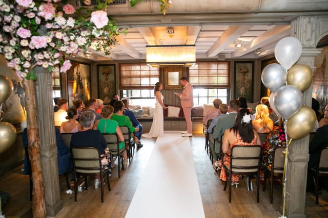 Elegant wedding setup with floral arrangements in Brasserie Paardenburg, promoting intimate events.