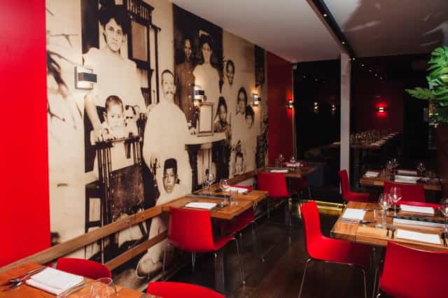 Vibrant Restaurant Blauw with mural and inviting red walls, perfect for events.