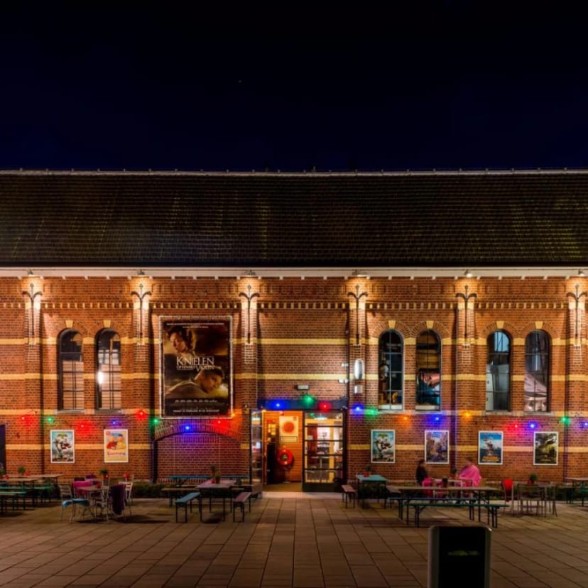 Illuminated historic brick pub venue for holiday gatherings and events.
