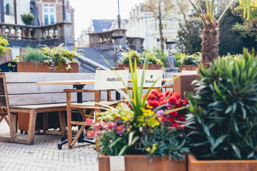 Charming outdoor seating area with wooden furniture for casual meetings in Park Zuid