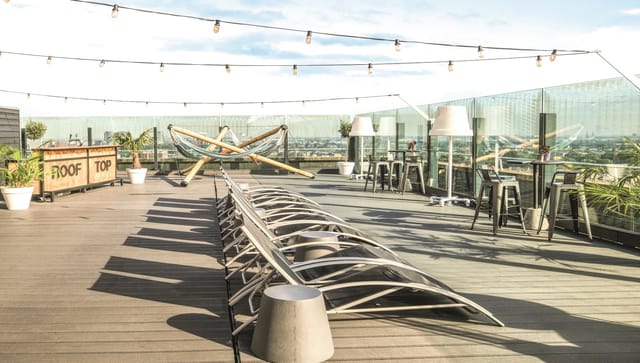 Stylish rooftop terrace event space with panoramic views and ambient lighting.