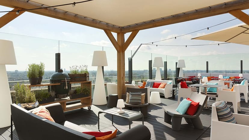 Stylish rooftop terrace with vibrant cushions for networking events and gatherings.