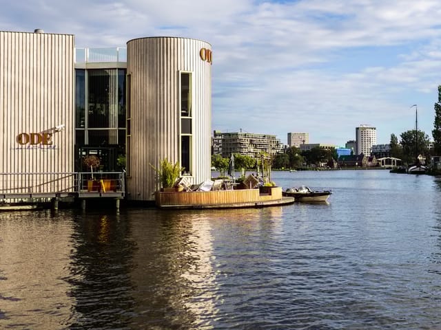 Modern waterfront event venue with wooden facades, ideal for retreats and gatherings.