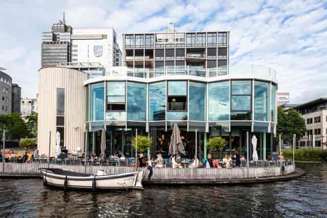Modern waterfront restaurant with large glass windows for events and gatherings.