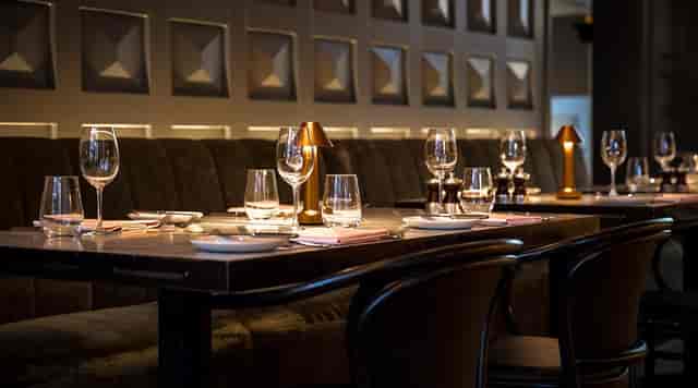 Semi-private dining room with elegant setup for intimate corporate dinners or networking events.