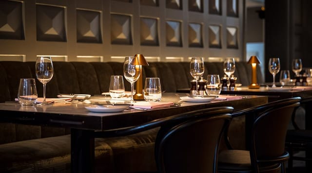 Semi-private dining room with elegant setup for intimate corporate dinners or networking events.